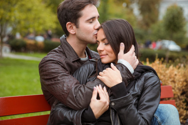 Couple hugging outdoors on the bench